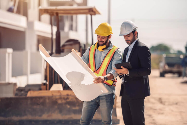 Construction workers reviewing plans on a job site