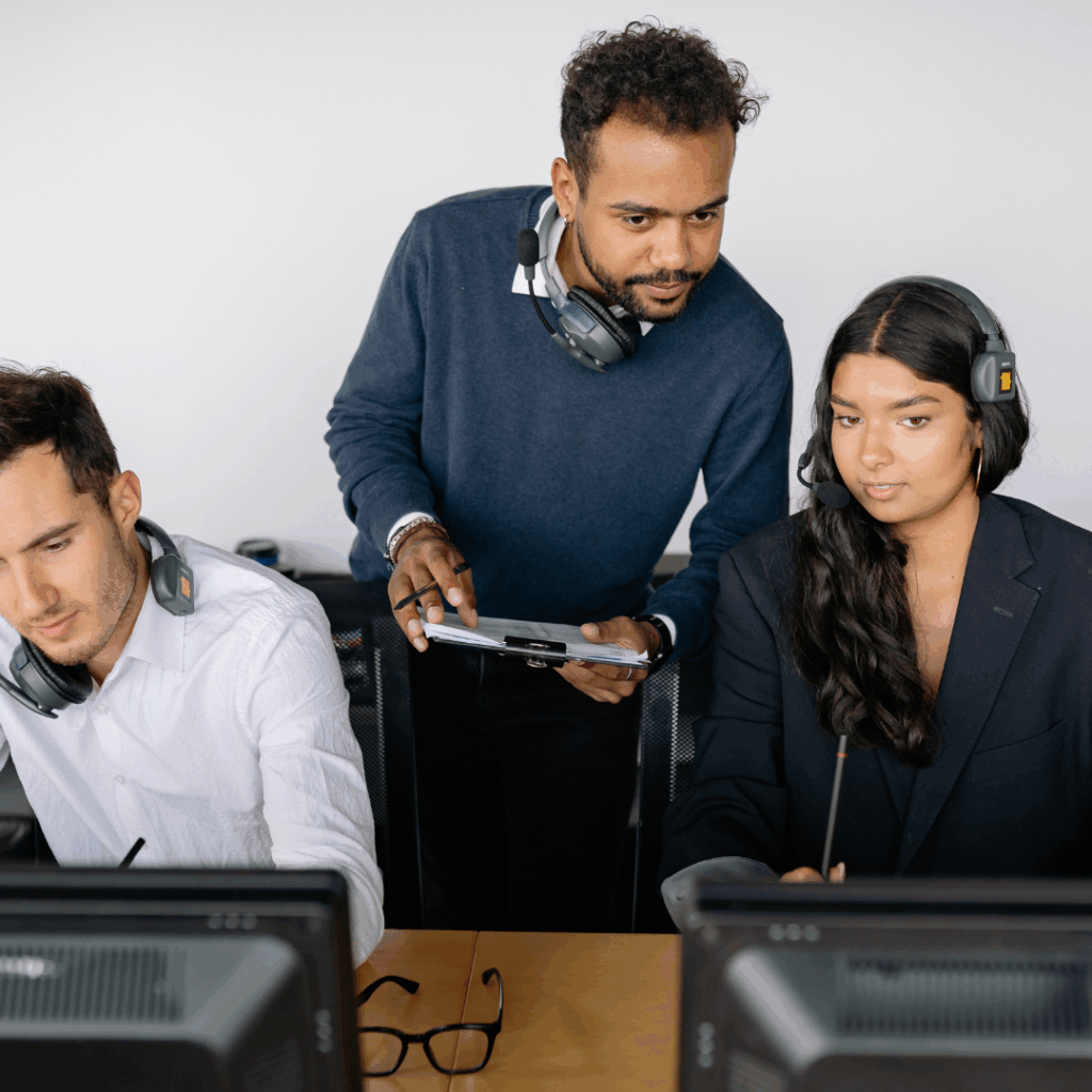 Three people at a desk during an employee security training cloud.