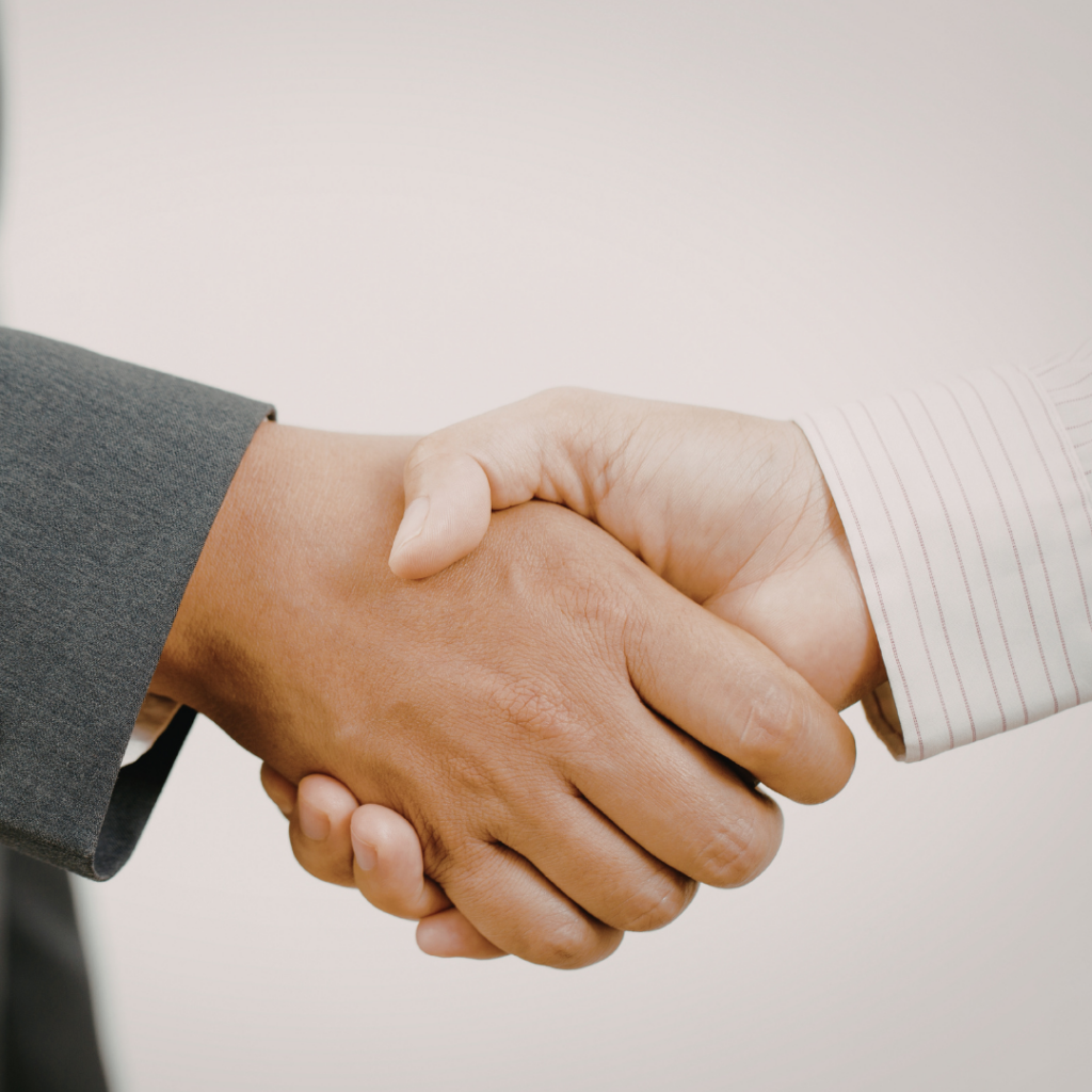 What Proactive IT Support Really Means (And Why It Matters More Than You Think) 2 Close-up of two people shaking hands, representing IT collaboration.