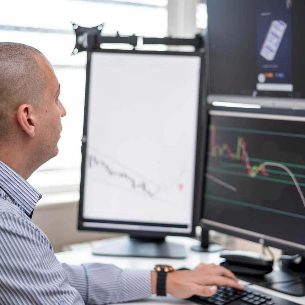 Poor AI Configurations are Killing Your Productivity 2 Person looking at several computer monitors, monitoring their AI usage.