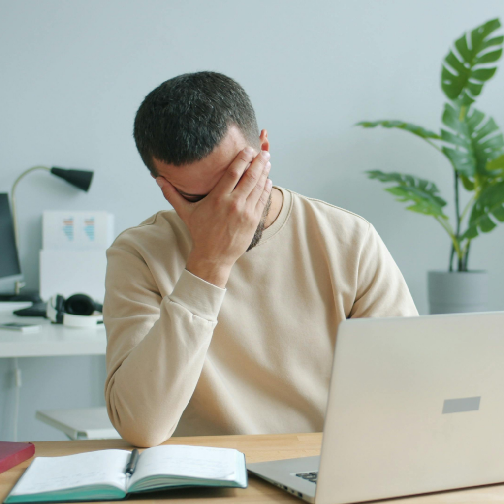 Essential Data Loss Prevention Strategies for the AI Age 1 Frustrated employee working on their laptop.