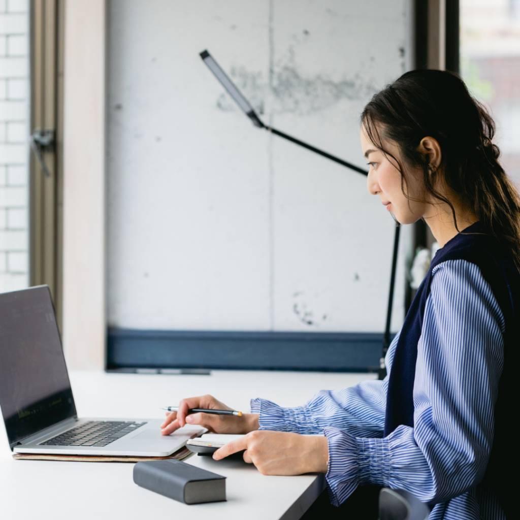 Poor AI Configurations are Killing Your Productivity 1 Person working on their laptop using AI Strategically.