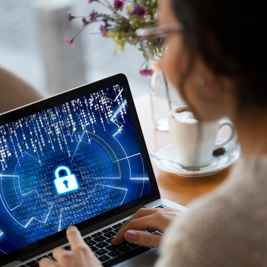 Cybersecurity Woman on laptop using cybersecurity strategies to protect her business in the AI age.