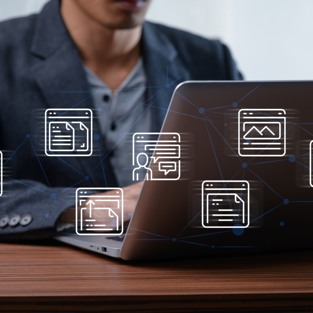7 Ways Cybersecurity Services Protect Your Business in the AI Age 1 Man on laptop with different forms of AI vendors floating on the screen.